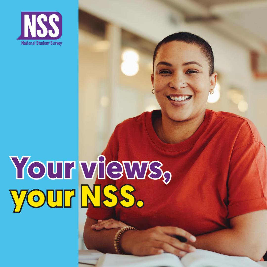 a student wearing a red t shirt sat at a desk with the words your views your NSS